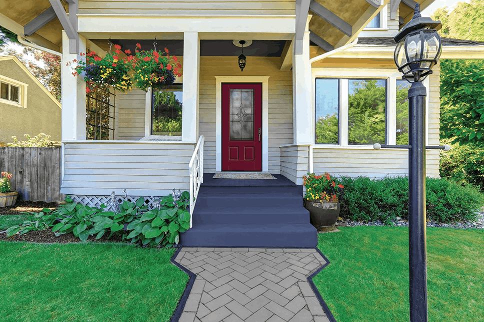 Craftsman-style home exterior with a red front door, white trim, and a landscaped front walkway.